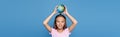 Smiling child holding globe above head Royalty Free Stock Photo