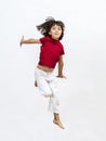 Smiling child jumping expressing success, dynamic childhood and open mindedness Royalty Free Stock Photo