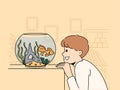 Smiling child look at goldfish in tank Royalty Free Stock Photo