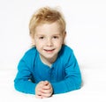 Smiling child lying down, looking at camera Royalty Free Stock Photo