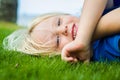 Smiling child lying on the grass outdoors