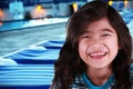 Smiling child by poolside at dusk