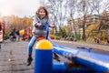 Smiling child on seesaw on the playground in the park