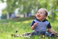Smiling child seting outdoors in summer park Royalty Free Stock Photo