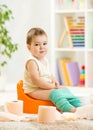 Smiling child sitting on chamber pot with toilet Royalty Free Stock Photo