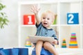 Smiling child sitting on chamber pot with toilet Royalty Free Stock Photo