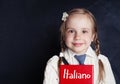 Smiling child student learning italian at the classroom