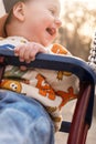 Smiling child on swing with fox-patterned sweater Royalty Free Stock Photo