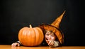 Smiling child in witch hat with jack-o-lantern. Happy Halloween party. Little kid with big pumpkin. Boy with Halloween Royalty Free Stock Photo