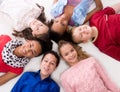 Smiling children with different complexion lying head to head Royalty Free Stock Photo