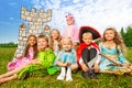 Smiling children in festival costumes sit close Royalty Free Stock Photo