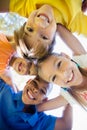 smiling children forming a huddle in circle