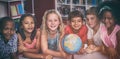 Smiling children with globe on table Royalty Free Stock Photo