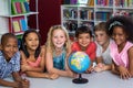 Smiling children with globe on table Royalty Free Stock Photo