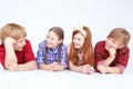 Smiling children lying on the floor in raw