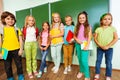 Smiling children stand close with textbooks Royalty Free Stock Photo
