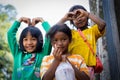 Smiling children standing side by side showing heart gestures