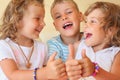 Smiling children three together shows ok gesture Royalty Free Stock Photo
