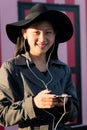 smiling chinese woman with phone and earphones Royalty Free Stock Photo
