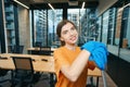 Smiling cleaning lady in coworking area in moments of relaxation Royalty Free Stock Photo