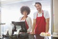 Smiling co-workers posing together behind the counter Royalty Free Stock Photo