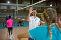 Coach giving high five to female player in volleyball court Royalty Free Stock Photo