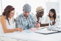 Smiling colleagues editing photos together Royalty Free Stock Photo