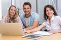 Smiling colleagues with laptop and digital tablet in meeting Royalty Free Stock Photo