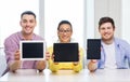 Smiling colleagues showing tablet pc blank screen