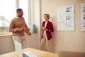 Smiling Colleagues Talking Office. Happy Business Couple Drinking Coffee Royalty Free Stock Photo