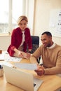 Smiling Colleagues Working At Office. Happy Business Couple Discussing Documents Royalty Free Stock Photo