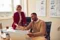 Smiling Colleagues Working At Office. Happy Business Couple Discussing Documents Royalty Free Stock Photo