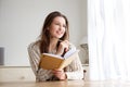 Smiling college student with book and pencil Royalty Free Stock Photo