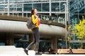 Smiling college student walking on college campus with bag Royalty Free Stock Photo