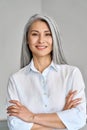 Vertical portrait of mature 50 years Asian business woman on grey background.