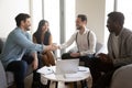 Smiling confident business partners shaking hand at group negotiations Royalty Free Stock Photo