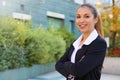 Smiling confident business woman looks at camera with crossed arms outdoor Royalty Free Stock Photo