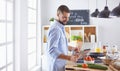 Smiling and confident chef standing in large kitchen Royalty Free Stock Photo