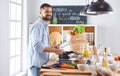 Smiling and confident chef standing in large kitchen Royalty Free Stock Photo