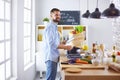 Smiling and confident chef standing in large kitchen Royalty Free Stock Photo