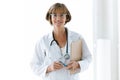 Smiling confident female doctor with eyeglasses looking at camera in the office at hospital. Royalty Free Stock Photo