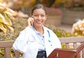 Smiling confident female doctor healthcare professional talking on phone Royalty Free Stock Photo