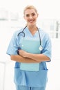 Smiling confident female doctor holding clipboard Royalty Free Stock Photo