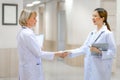 Smiling confident female doctor team shaking hand at the hospital, Medicine and health care concepts Royalty Free Stock Photo