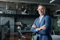 Confident happy mid aged business man standing in office arms crossed, portrait. Royalty Free Stock Photo