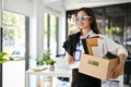 Smiling Asian female office worker celebrating her resignation, happy to quit her job Royalty Free Stock Photo