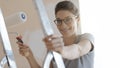 Happy woman painting walls in her new apartment Royalty Free Stock Photo