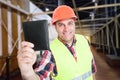 Smiling construction worker with money wallet