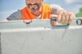 Smiling constructor worker using a spirit level