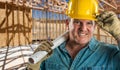 Helpful Contractor in Hard Hat Holding Floor Plans At Construction Site Royalty Free Stock Photo